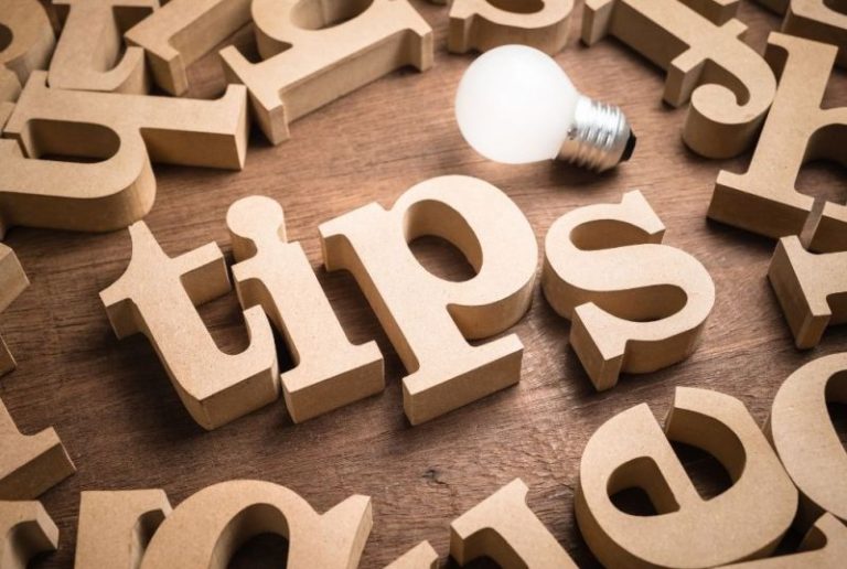 a light bulb next to wooden letters spelling "Tips"